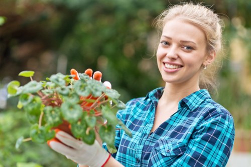 Worker using safe landscaping practices with protective equipment